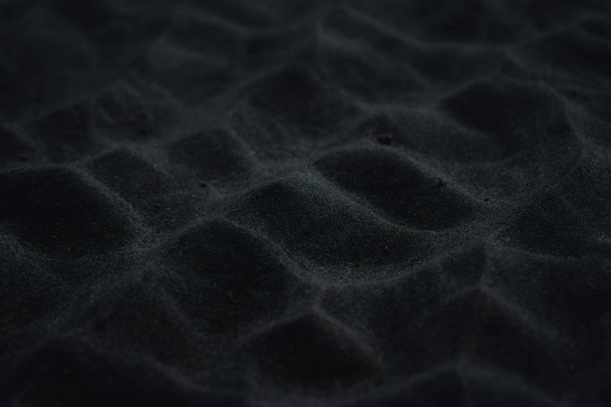 a close up of a black sand texture