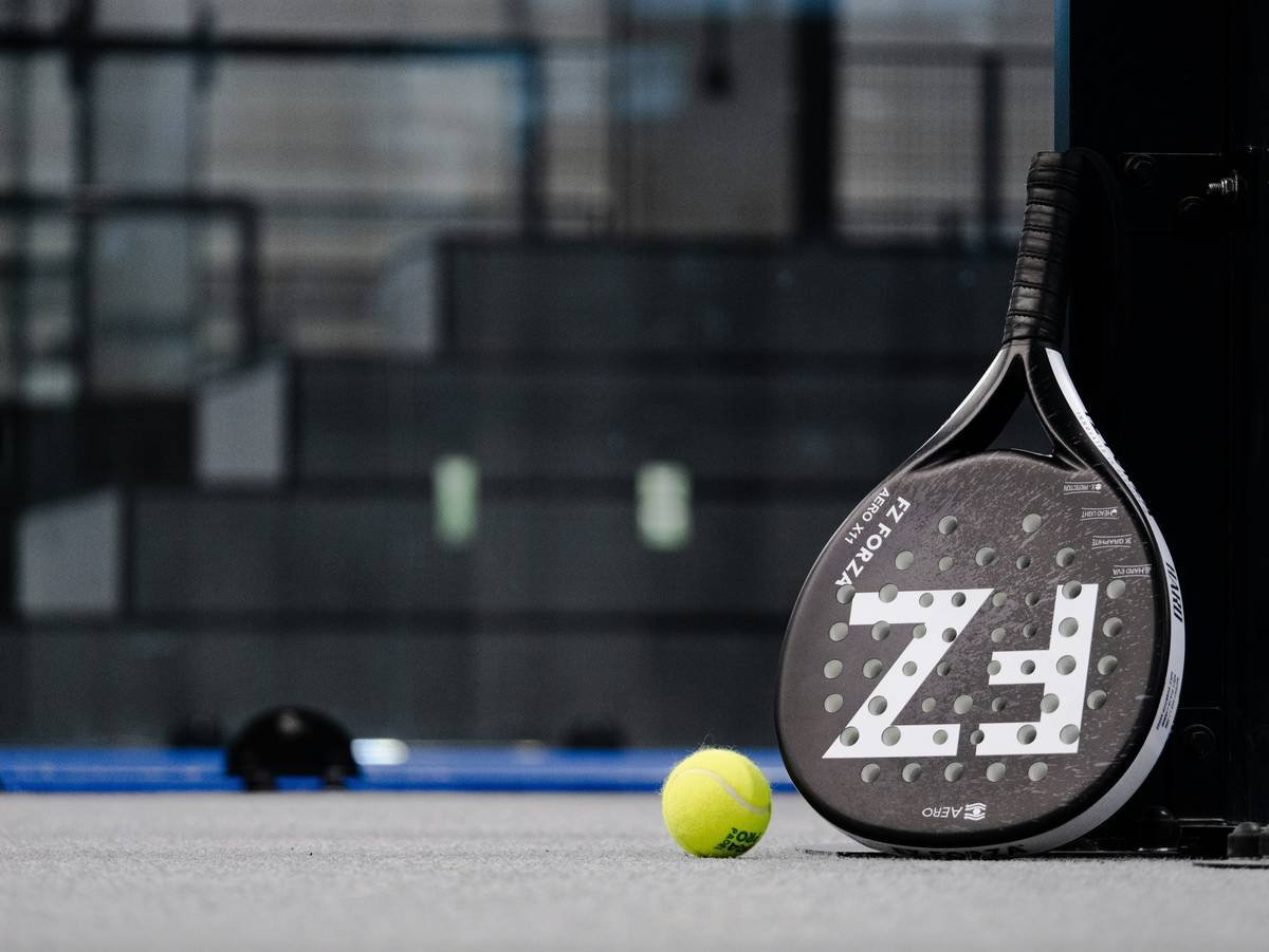 Player executing smash shot with speed pro ball type in professional padel match